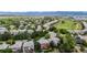 Aerial view of a neighborhood with lush green grass and a golf course in the background at 3126 Aspen Creek Dr, Highlands Ranch, CO 80129
