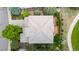 An aerial view looking down on a light grey house with an intricate roof in a neighborhood at 3126 Aspen Creek Dr, Highlands Ranch, CO 80129
