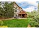 Backyard with a patio featuring a hot tub, a lawn, and mature landscaping at 3126 Aspen Creek Dr, Highlands Ranch, CO 80129