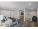 Staged basement bedroom and living area with modern furniture, laminate flooring, and neutral walls at 3126 Aspen Creek Dr, Highlands Ranch, CO 80129