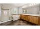 Bathroom featuring a glass shower, large tub, wood cabinets, and neutral countertops at 3126 Aspen Creek Dr, Highlands Ranch, CO 80129