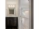 Modern bathroom featuring a dark wood vanity, granite countertop, and updated lighting fixtures at 3126 Aspen Creek Dr, Highlands Ranch, CO 80129