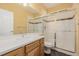 Bathroom with a white quartz vanity, glass enclosed shower, and tile accents at 3126 Aspen Creek Dr, Highlands Ranch, CO 80129