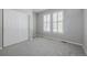 Empty bedroom featuring closet, gray carpet and large double window with white shutters at 3126 Aspen Creek Dr, Highlands Ranch, CO 80129