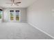 Spacious bedroom featuring neutral walls, carpet, ceiling fan, and double doors to a balcony at 3126 Aspen Creek Dr, Highlands Ranch, CO 80129