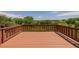 Spacious wooden deck overlooking a green space with mature trees and serene surroundings at 3126 Aspen Creek Dr, Highlands Ranch, CO 80129