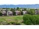 Homes with landscaped yards overlooking a scenic golf course and mountain views at 3126 Aspen Creek Dr, Highlands Ranch, CO 80129