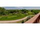 An elevated view of a perfectly manicured golf course with mature trees at 3126 Aspen Creek Dr, Highlands Ranch, CO 80129