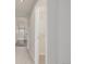 Hallway with view into a bathroom and an open closet with wire shelving at 3126 Aspen Creek Dr, Highlands Ranch, CO 80129