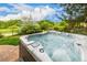 A close-up view of a jetted hot tub overlooking the golf course at 3126 Aspen Creek Dr, Highlands Ranch, CO 80129