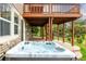 The hot tub is underneath a wooden deck and overlooks the yard at 3126 Aspen Creek Dr, Highlands Ranch, CO 80129