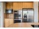 A close-up of stainless steel appliances, including a double oven, microwave and refrigerator at 3126 Aspen Creek Dr, Highlands Ranch, CO 80129
