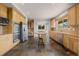 Open concept kitchen with wooden cabinets, island cooktop, stainless steel appliances and slate floors at 3126 Aspen Creek Dr, Highlands Ranch, CO 80129