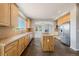 Spacious kitchen featuring wooden cabinets, tile backsplash, central island and stainless steel appliances at 3126 Aspen Creek Dr, Highlands Ranch, CO 80129