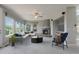 Comfortable living room featuring large windows, a cozy fireplace, and stylish furnishings at 3126 Aspen Creek Dr, Highlands Ranch, CO 80129