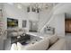 A spacious living room boasting high ceilings, a statement chandelier, and a staircase to the second floor at 3126 Aspen Creek Dr, Highlands Ranch, CO 80129