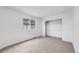 Carpeted bedroom featuring window view and closet space at 12678 W Dorado Pl, Littleton, CO 80127