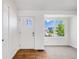 Bright entryway with wood floors, a white front door and a large window providing natural light at 12678 W Dorado Pl, Littleton, CO 80127