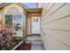 Inviting front entry with neutral siding, window, and a white front door with sidelight at 12678 W Dorado Pl, Littleton, CO 80127