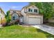 Charming two-story home with a well-manicured lawn, brick accents, and an attached two-car garage at 12678 W Dorado Pl, Littleton, CO 80127