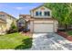 Charming two-story home with a two-car garage and well-maintained landscaping on a sunny day at 12678 W Dorado Pl, Littleton, CO 80127