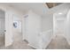 Bright hallway with neutral carpet and white accents leads to bedrooms at 12678 W Dorado Pl, Littleton, CO 80127