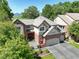 Aerial view of a beautiful brick home showcasing the driveway and surrounding landscape at 11904 W Auburn Dr, Denver, CO 80228
