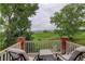 A covered back porch with seating overlooks a scenic golf course and mountain range at 11904 W Auburn Dr, Denver, CO 80228
