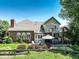 Backyard showcasing an outdoor dining area and a cozy hot tub with mature landscaping at 11904 W Auburn Dr, Denver, CO 80228