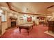 Finished basement with pool table, brick fireplace, and bar area for entertaining at 11904 W Auburn Dr, Denver, CO 80228