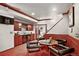This basement features a bar with a wine fridge and cozy seating around a table with a laptop at 11904 W Auburn Dr, Denver, CO 80228
