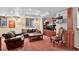 Relaxing basement living room with plush seating, custom built-ins, and a television at 11904 W Auburn Dr, Denver, CO 80228
