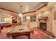 Finished basement with pool table, fireplace, TV, and sofa for comfortable relaxation at 11904 W Auburn Dr, Denver, CO 80228