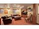 Finished basement featuring comfortable seating, built-in cabinets, and a stone-accented window at 11904 W Auburn Dr, Denver, CO 80228
