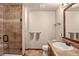 This bathroom features a tiled shower and a vanity sink with a mirror at 11904 W Auburn Dr, Denver, CO 80228