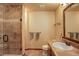 Well-lit bathroom featuring a glass-enclosed shower and a stylish vanity at 11904 W Auburn Dr, Denver, CO 80228