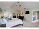 This bedroom features high vaulted ceilings, a ceiling fan, and neutral tones, creating a peaceful retreat at 11904 W Auburn Dr, Denver, CO 80228