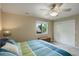 Bright bedroom features carpet, a double door closet, and a bed with blue and green accents at 11904 W Auburn Dr, Denver, CO 80228