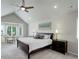 A bright bedroom is seen with vaulted ceilings, neutral tones, large windows, and modern decor at 11904 W Auburn Dr, Denver, CO 80228
