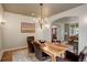 Stylish dining room showcases a wooden table, chandelier, and elegant decor at 11904 W Auburn Dr, Denver, CO 80228