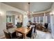 Inviting dining room features a wooden table, chandelier, and seamless flow into adjacent living spaces at 11904 W Auburn Dr, Denver, CO 80228