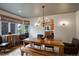 Bright dining area boasts a wooden table, stylish chairs, and window views at 11904 W Auburn Dr, Denver, CO 80228