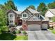 Inviting two-story home featuring a three-car garage and manicured front yard at 11904 W Auburn Dr, Denver, CO 80228