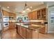 Gourmet kitchen with granite counters, stainless appliances, and a center island with gas cooktop at 11904 W Auburn Dr, Denver, CO 80228