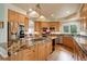 Spacious kitchen with stainless steel appliances, granite countertops, and a large center island at 11904 W Auburn Dr, Denver, CO 80228