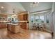 Bright kitchen features a center island with cooktop, stainless appliances, and eat-in dining area at 11904 W Auburn Dr, Denver, CO 80228