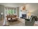 Comfortable living area featuring a fireplace, plush seating, and bright natural lighting at 11904 W Auburn Dr, Denver, CO 80228
