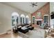 Cozy living room features a brick fireplace, built-in shelving, and large windows at 11904 W Auburn Dr, Denver, CO 80228