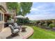 Relaxing outdoor patio area with comfortable seating, a fire pit, and a lush garden at 11904 W Auburn Dr, Denver, CO 80228