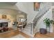 Elegant staircase with decorative iron railings, leading to an open living area at 11904 W Auburn Dr, Denver, CO 80228